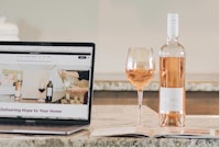 a laptop with a bottle of wine and a bottle of wine on it