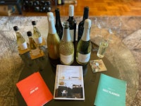 a table with bottles of wine and a book on it